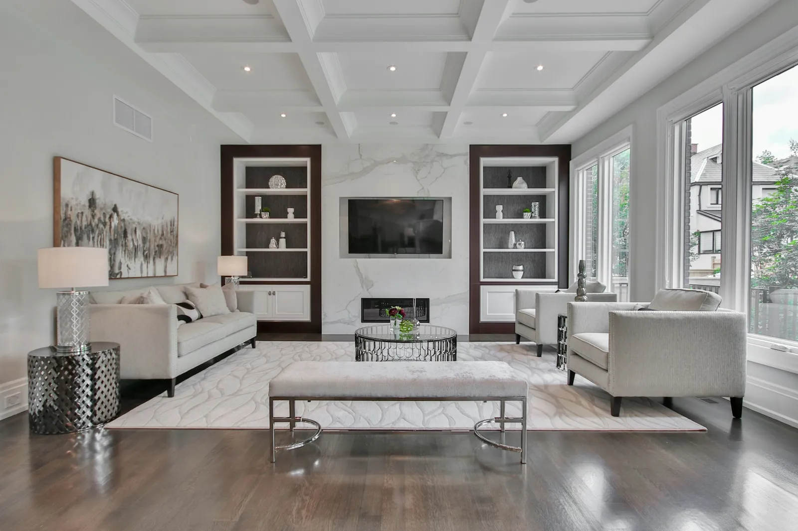 A finished residential living space with integrated storage, pale walls, and wood flooring.